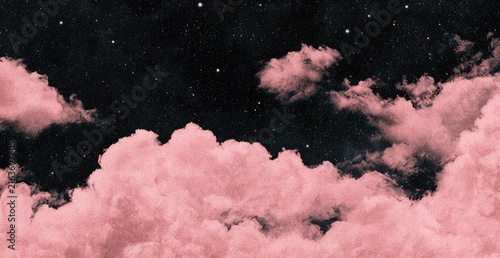 Soft pink clouds drift across a dark starry sky