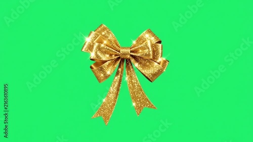 Animation golden bow on green background.