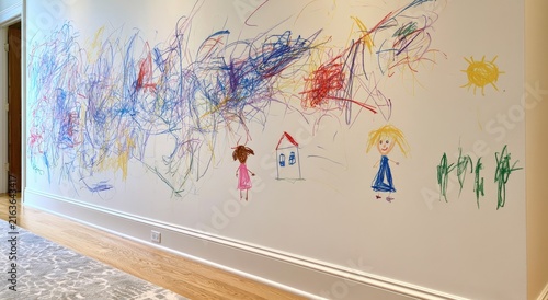 A sprawling wall mural of colorful scribbles and childlike drawings