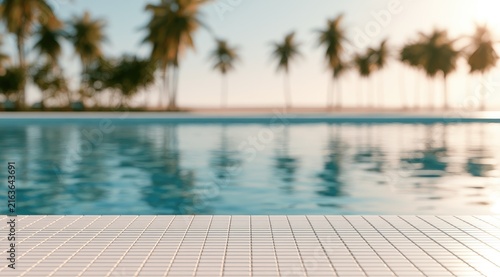 Serene poolside with blurred palm trees and ocean at sunset