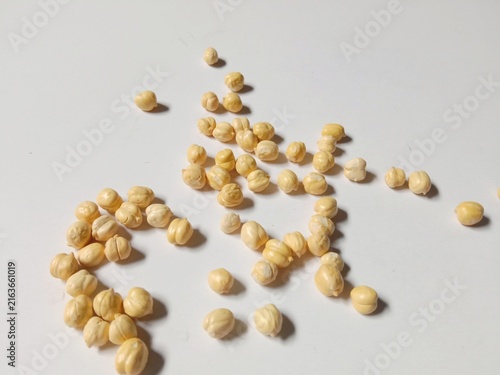 Dried Chickpeas Scattered on White Background with Natural Shadows