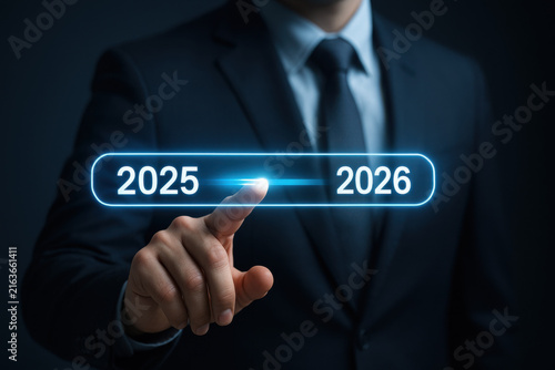 Businessman touching futuristic digital progress bar glowing interface showing years 2025 and 2026, symbolizing timeline and future planning in technology and business