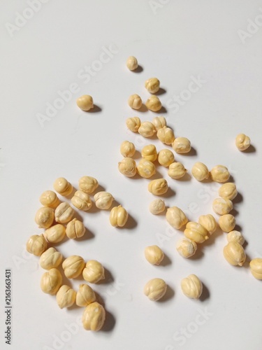 Dried Chickpeas Scattered on White Background with Natural Shadows