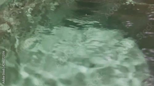 Abstract background of turquoise water moving gently in a river stream.