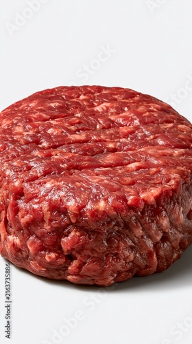 Raw ground beef patty providing protein, ideal for burgers or cooking preparation