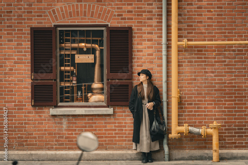 Photography Stylish traveler gazing beside vintage whisky boutique window, Jianyeli, Shangha