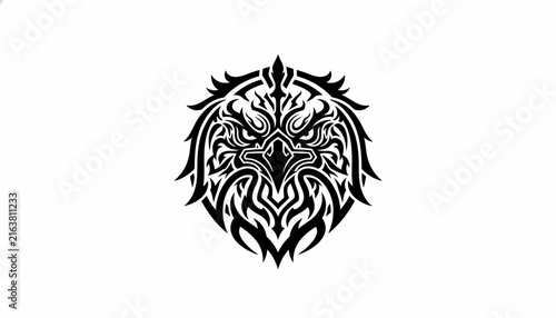 A striking black and white tribal tattoo design featuring the fierce face of an eagle with intricate patterns.