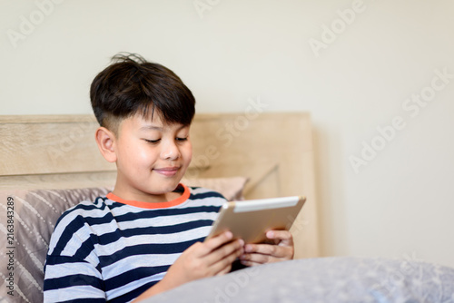 Konstfotografi Childhood digital immersion concept showcasing focused tablet interaction and on