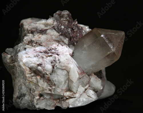 Cuadro en lienzo A macro close-up view of a quartz specimen featuring a prominent, well-formed smoky quartz crystal protruding from a light-colored matrix of quartz and feldspar against a dark background
