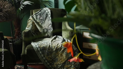 Moody Green Vintage Living Room Interior with Velvet Armchairs and Tropical Leaves