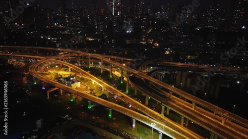 Drone hyperlapse aerial shot of Atal Setu in Mumbai at night, showcasing the dynamic cityscape illuminated with vibrant lights. The footage captures the fast-paced movement of traffic and clouds.