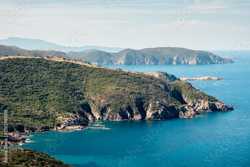 Coastal landscape with turquoise water and steep cliffs, Corsica Island