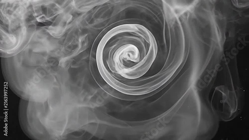 Abstract white smoke swirls rising against a deep black background