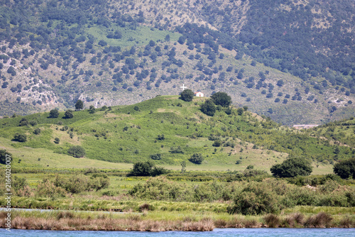 View of a small Orthodox church in the landscape of Lake Butrint - Albania