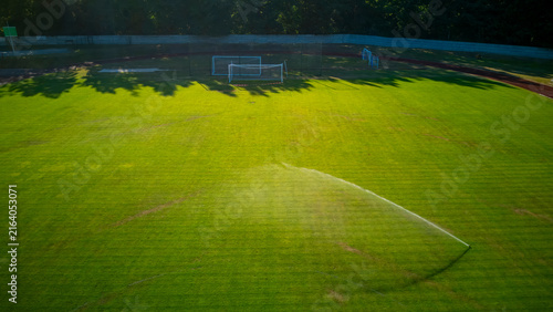 Drone, aerial view of football pitch irrigation during a dry summer.