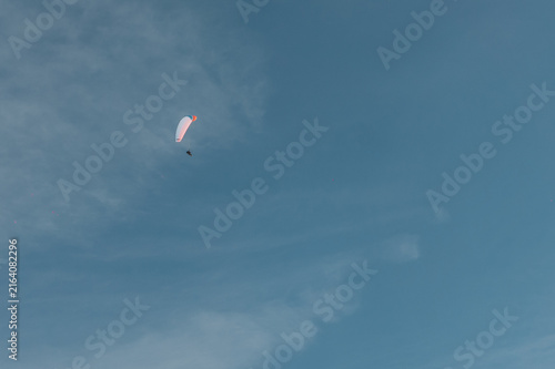 Bild auf Leinwand skydiver with parachute fly in sky far away