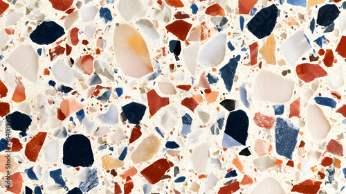 Top view of colorful terrazzo surface with a mix of red, blue, and neutral stones, creating a vibrant and textured pattern.
