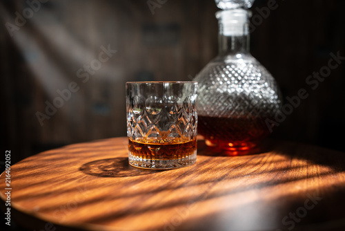 Whiskey Glass and Crystal Decanter on Wooden Table