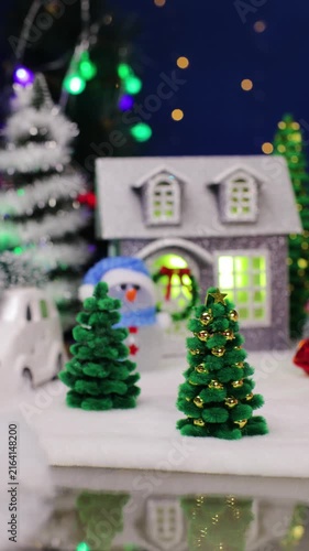Ahead of the Christmas town is a yellow car with a Christmas tree on the roof