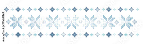 The pattern is embroidered with a cross stitch. Traditional Ukrainian ornament with flowers.