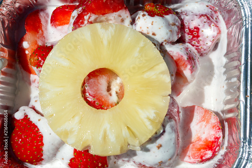 Fresh strawberries with pineapple in sour cream.