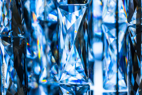 Macro close up of faceted blue crystal chandelier pattern texture background