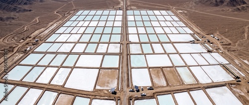 Aerial view of a vast outdoor lithium mining operation in atacama desert, chile, with evaporation ponds for mineral extraction