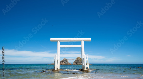 Meoto Iwa, white torii gate standing in the sea with sacred rocks in Itoshima, Fukuoka, Japan