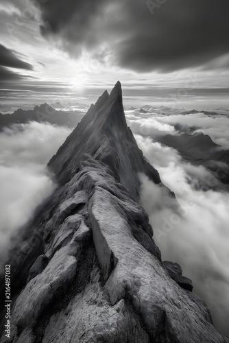 Mountain peak rising above the clouds 