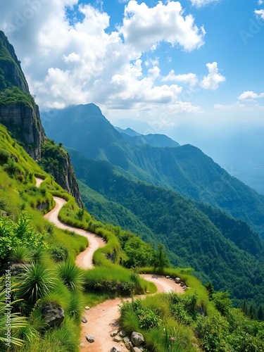 Winding mountain trail through lush green slopes under blue sky