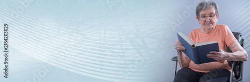 Senior woman reading a book; panoramic banner
