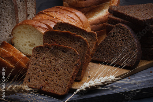 Bread still life. Variety of sliced ​​rye and wheat breads.