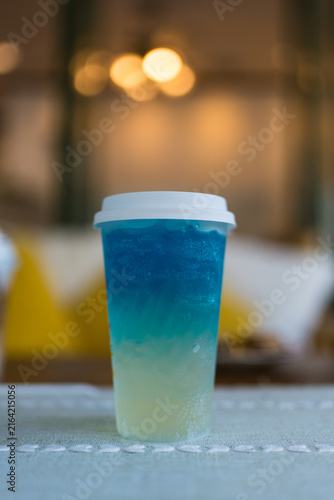 Closeup cocktail or tropical mocktail. A plastic glass of Blue Hawaii Italian Soda