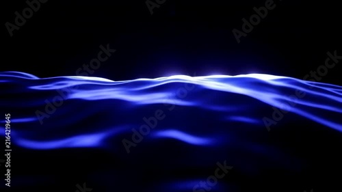 Blue ocean waves gently rolling under soft light, creating a serene atmosphere against a dark background, showcasing the fluid motion of water in a tranquil setting