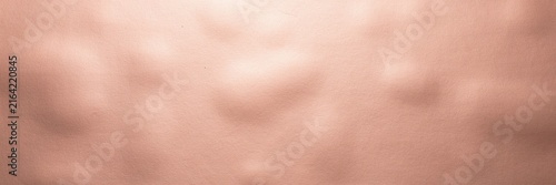 Rose gold abstract background with soft bokeh light, elegant pink metallic texture with blurred highlights, luxury copper shimmer surface for cosmetic branding and wedding invitations