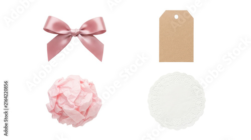 Pink satin bow, kraft tag, tissue paper ball, lace doily on white background