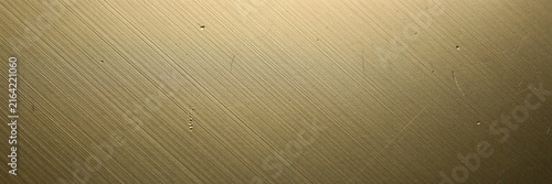 Brushed gold metal texture with diagonal lines, elegant metallic brass surface background for luxury branding, industrial golden steel plate with fine hair line finish and soft lighting