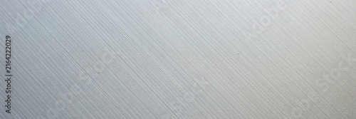 Brushed aluminum metal texture background, silver stainless steel surface with diagonal hair lines, industrial metallic plate material for modern architectural design and tech backdrops