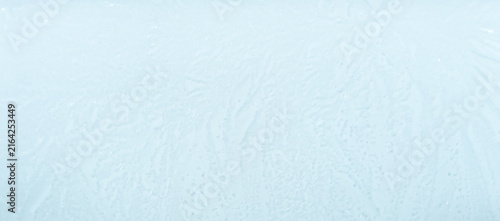 Light blue ice texture background with delicate frost patterns, horizontal winter backdrop with space for text. Space for text 