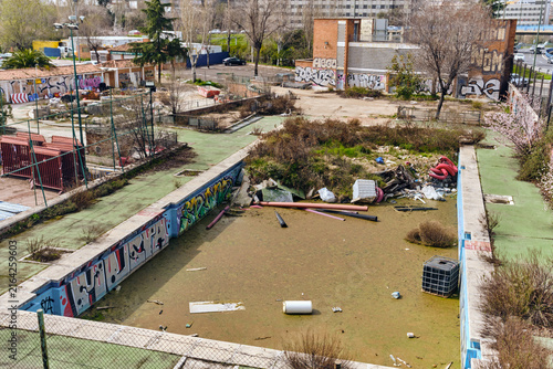 Fotografie Urban decay and abandonment in Madrid Spain neglected swimming pool with graffit