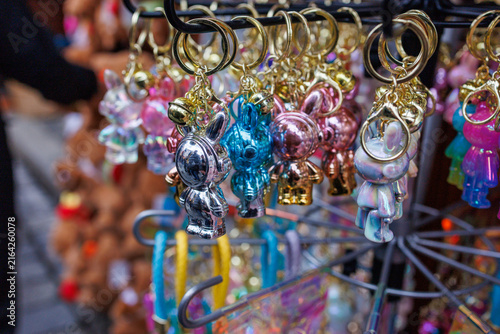 Fotografie Colorful metallic rabbit keychains hanging on retail display stand