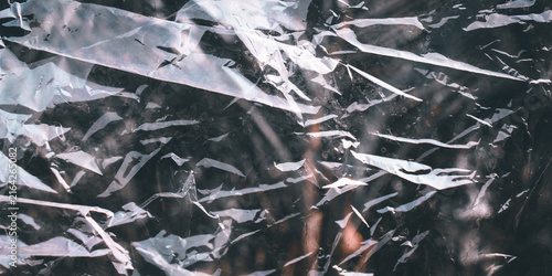 a transparent plastic sheet that is crumpled, folded, and wrinkled