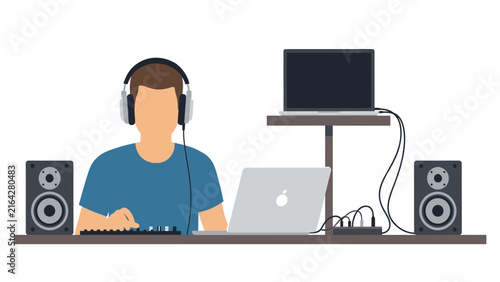 Man wearing headphones working at a desk with a laptop, speakers, and audio equipment.