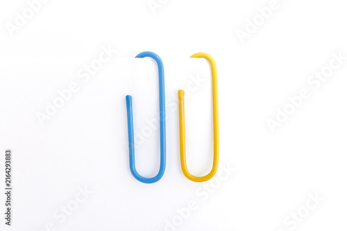 Blue and Yellow Paperclips on Paper