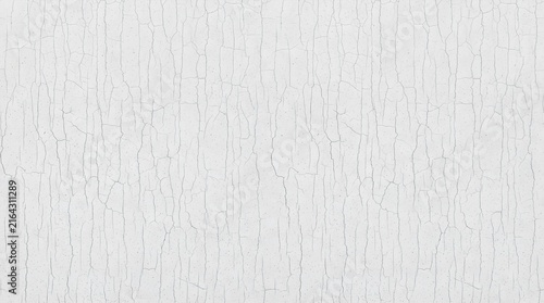 A close-up view of a white textured surface with a subtle cracked pattern
