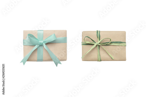Cutout image of two naturally styled gifts decorated with pale green ribbons of different materials.