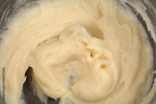 Obraz na plátně A full frame close up view showing the thick smooth texture of a creamy flour mixture cooked with milk and water inside a pan