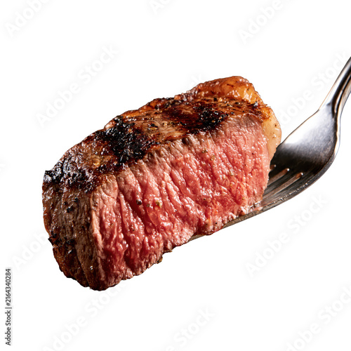 Juicy grilled steak on fork showcases a delicious piece of meat prepared for a meal in a kitchen setting