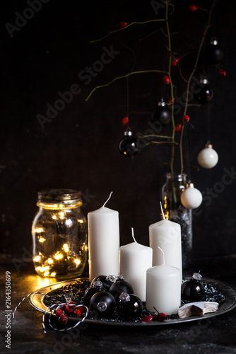 Advent decoration with white candles and black baubles