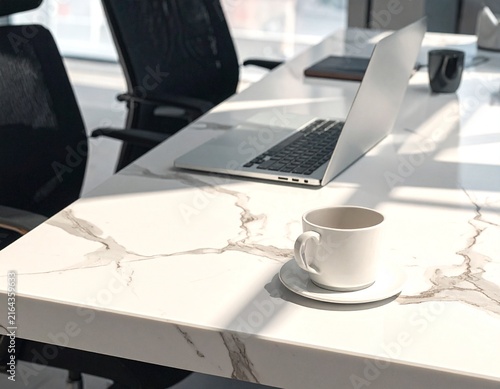 Professional workspace with laptop and coffee cup in contemporary office interior